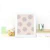 Florals Illustrated in Orchid on a Cream Background on Desk