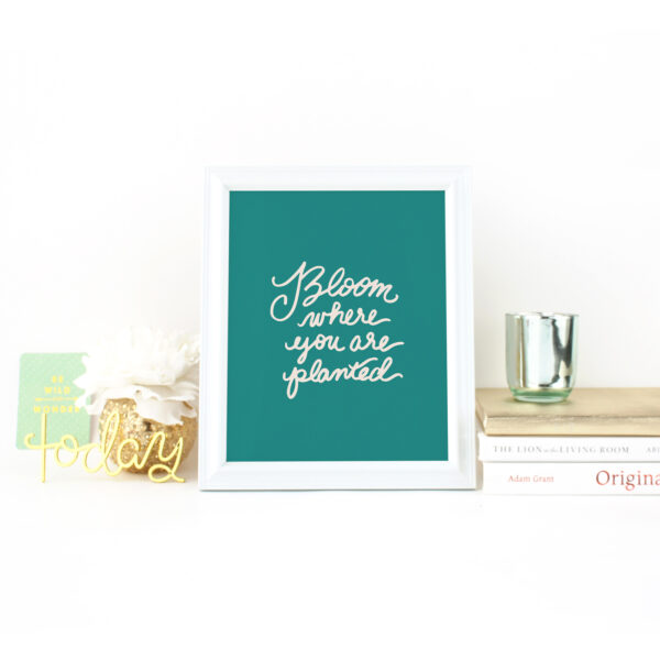Bloom Where You Are Planted handlettered in Sand on Green background on Desk