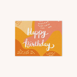 Happy Birthday handelletered in white on monarch yellow, sunset pink, and creme abstract background