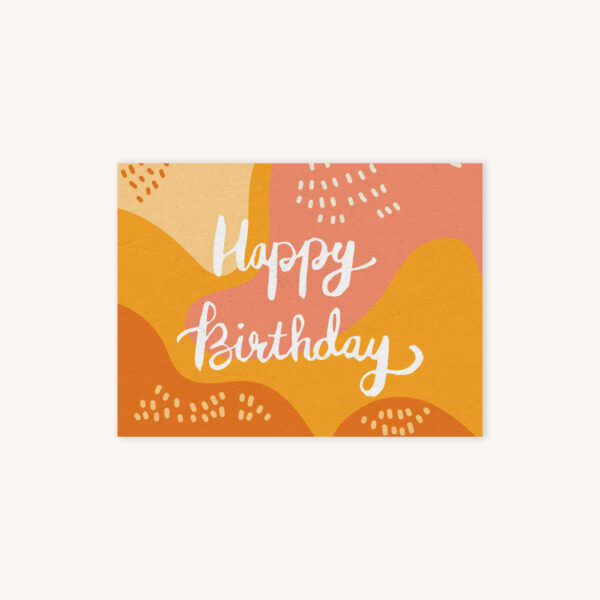 Happy Birthday handelletered in white on monarch yellow, sunset pink, and creme abstract background