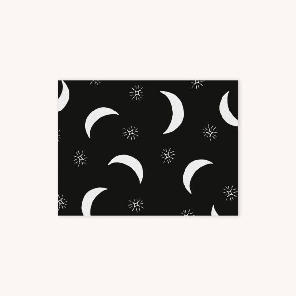 Black notecard featuring white moons and sparkles