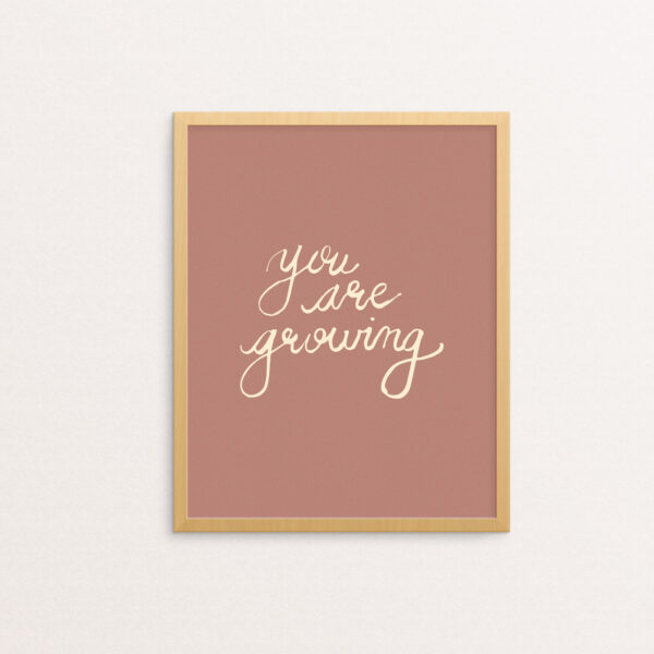You Are Growing hand-lettered in light pink on a rouge background