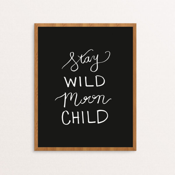 Stay Wild Moon Child Handlettered in White on Black Paper in a Wooden Frame