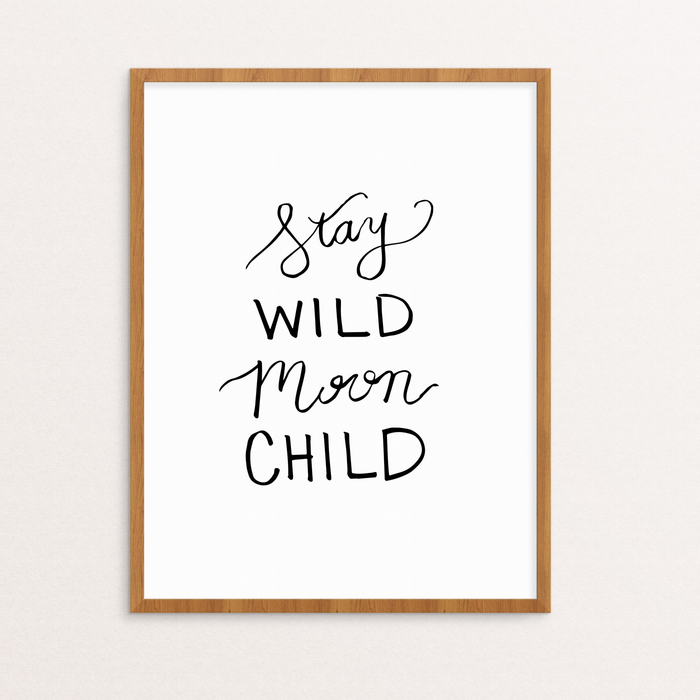 Stay Wild Moon Child Handlettered in Black on White Paper in a Wooden Frame