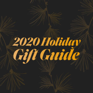 2020 Holiday Gift Guide typed in a gold gradient on top of a black background with gold winter foliage behind it