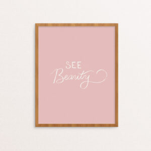 Art print with "See Beauty" hand lettered in white on a soft pink background