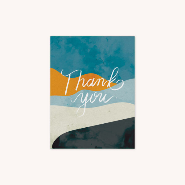 A greeting card featuring the phrase Thank You handlettered in white on ablue, gold, light blue, gray, and charcoal gray wavy abstract background