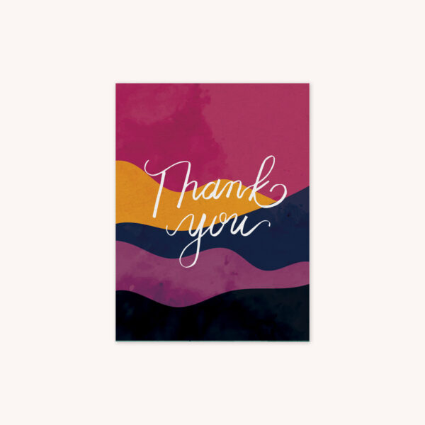 A greeting card featuring the phrase Thank You handlettered in white on ablue, gold, light pink, yellow ,navy, purple, and charcoal gray wavy abstract background