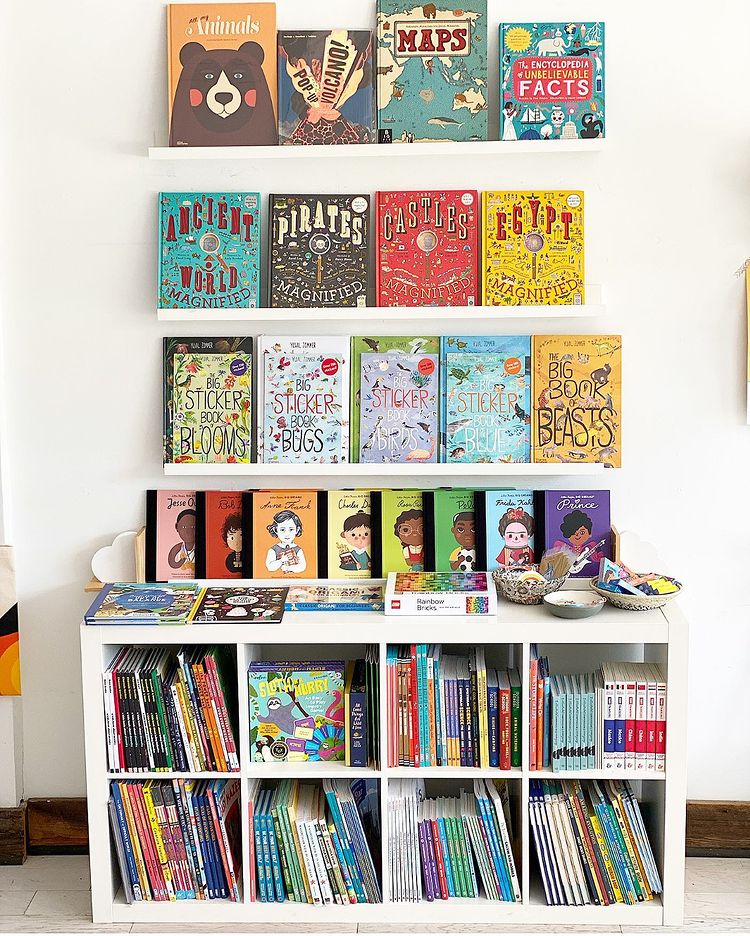 Many childrens book on white bookshelves