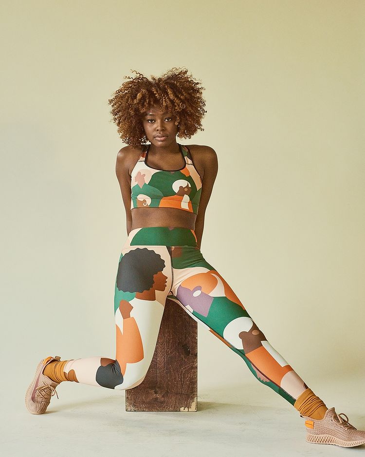 Woman wearing brightly colored abstract athleisure during a styled shoot