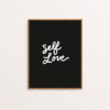 Art print with "Self Love" hand lettered in white on a black background